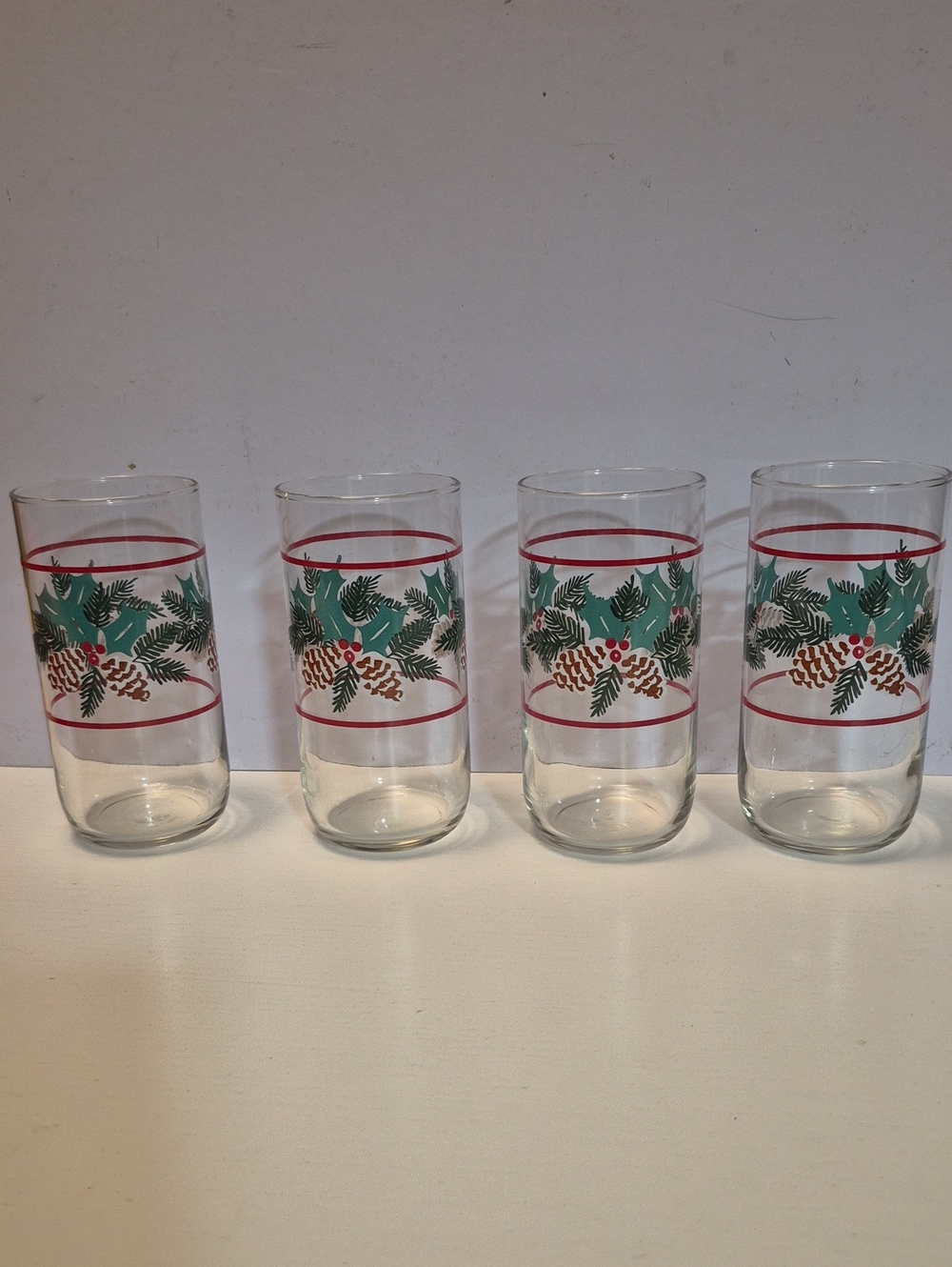 These vintage Christmas highball glasses feature a festive green pine and holly